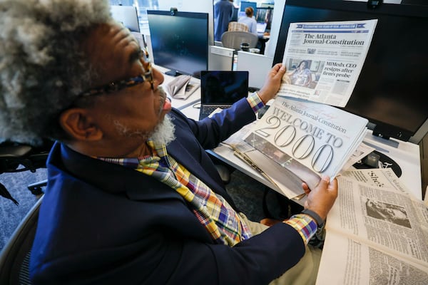 Ernie Suggs, a reporter at the AJC since 1997, reviews a collection of newspaper articles he’s worked on during his tenure, as of Wednesday, Nov. 5, 2025. (Miguel Martinez/AJC)
