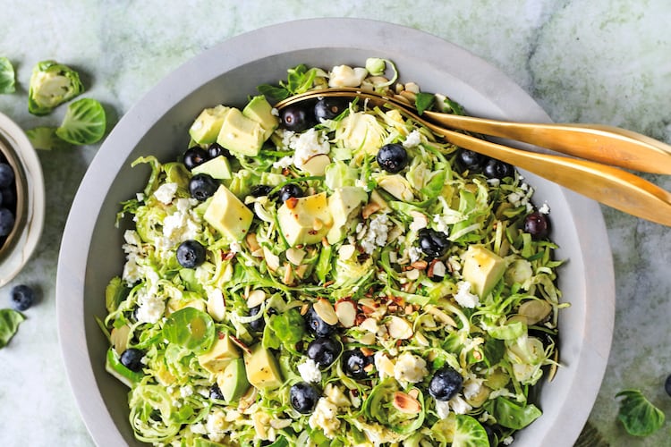 This Brussels sprout salad is dressed in a white balsamic vinaigrette and topped with fresh blueberries, sliced almonds and crumbly feta. (Reprinted with permission from “Every Salad Ever” by Greta Podleski, copyright © 2025. Published by Clarkson Potter, a division of Penguin Random House LLC)