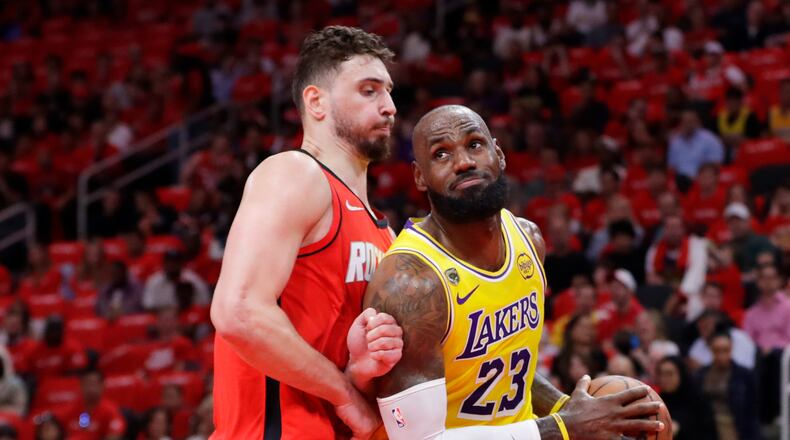 Los Angeles Lakers forward LeBron James (23) drives to the basket in front of Houston Rockets center Alperen Sengun, left, during the first half of Game 3 in a first-round NBA playoffs basketball series Friday April 24, 2026, in Houston. (AP Photo/Michael Wyke)