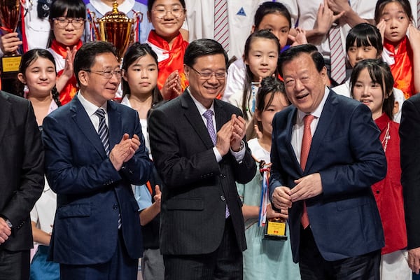 Zhou Ji, director of the Liaison Office of the Central People's Government, from left, John Lee, Hong Kong Chief Executive, and Xia Baolong, director of Hong Kong & Macao Affairs Office, attend the 5th anniversary of Hong Kong National Security Law Forum in Hong Kong, Saturday, June 21, 2025. (AP Photo/Chan Long Hei)