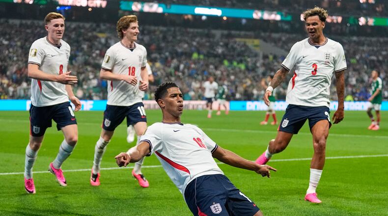 England's Jude Bellingham (10) celebrates with teammates after scoring his second goal during the World Cup round of 16 soccer match between Mexico and England in Mexico City, Sunday, July 5, 2026. (AP Photo/Natacha Pisarenko)