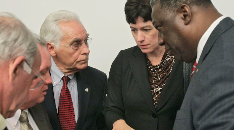 Tom Worthan, third from left (red tie), consults with other county commission chairs from around metro Atlanta in 2011. Worthan is a three-term chairman. (AJC file / Bob Andres)