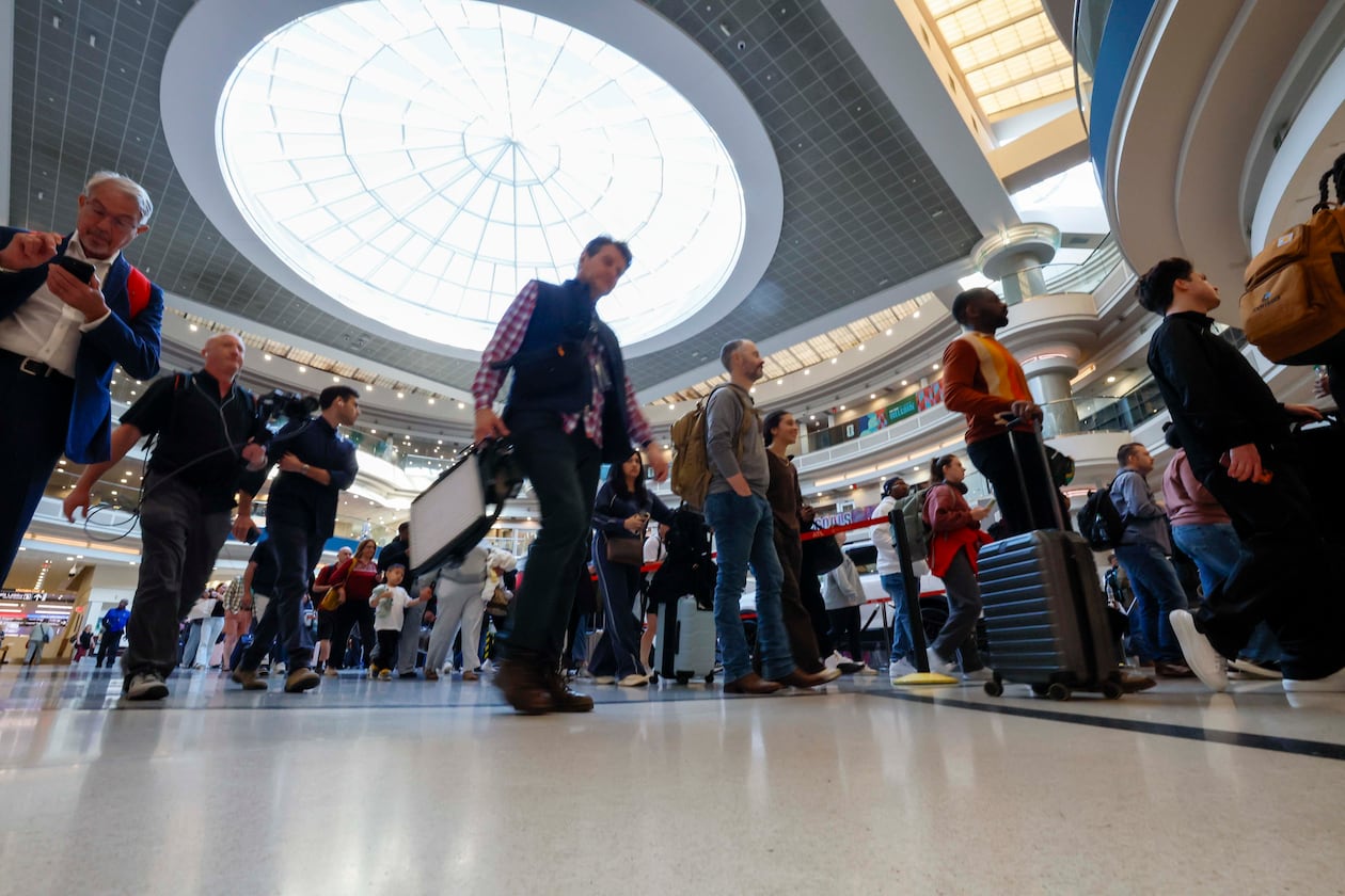 Travelers line up at the atrium approaching the Main checkpoint for security screening early Monday, March 23, 2026, at Hartsfield-Jackson Atlanta International Airport. The airport was again the world’s busiest in 2025 with 106.3 million passengers. (Miguel Martinez/AJC)