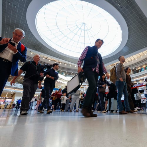 Travelers line up at the atrium approaching the Main checkpoint for security screening early Monday, March 23, 2026, at Hartsfield-Jackson Atlanta International Airport. The airport was again the world’s busiest in 2025 with 106.3 million passengers. (Miguel Martinez/AJC)