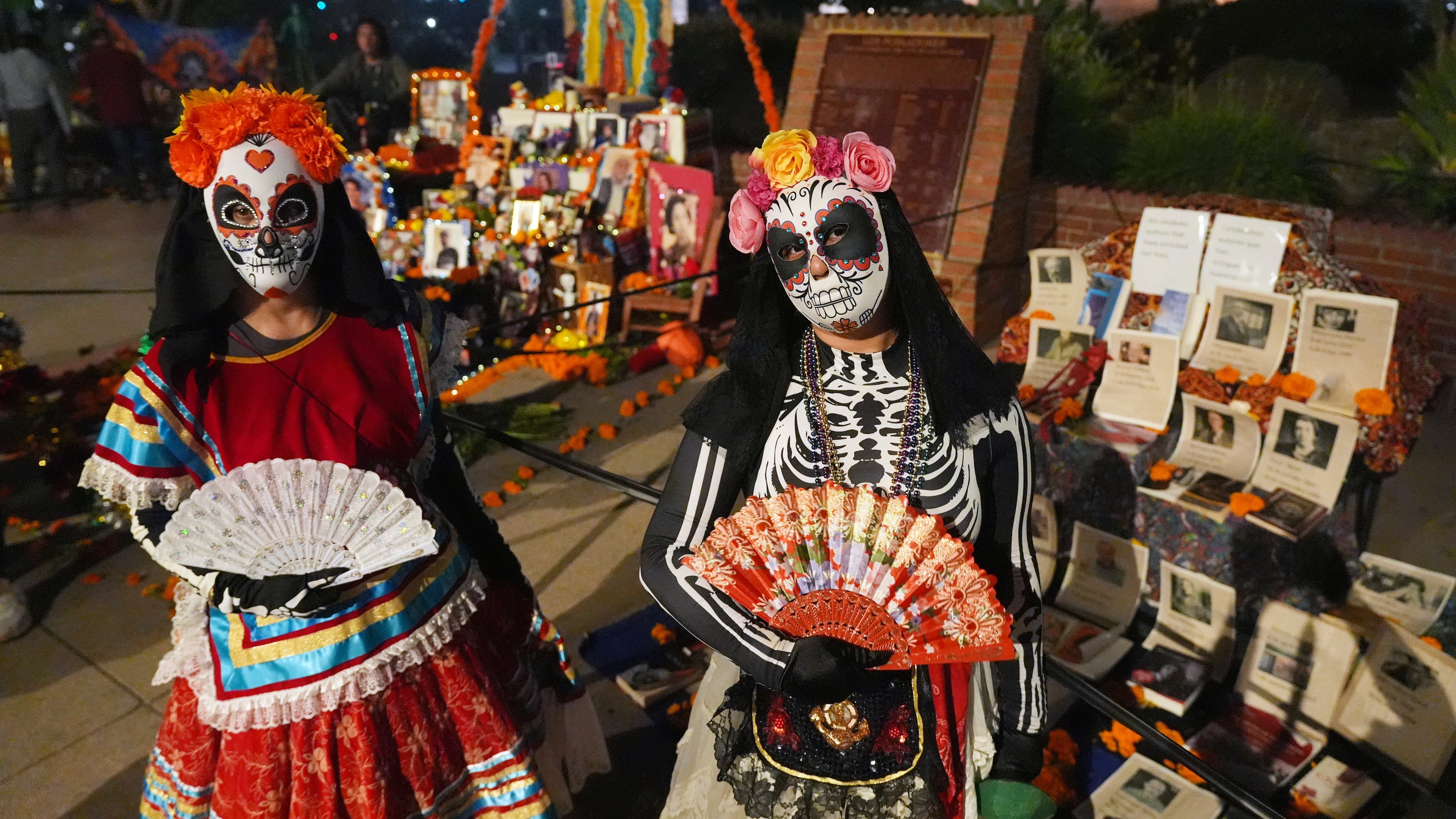 People join Olvera Street merchants in a night procession during the Day of the Death festival, Sunday, Oct. 26, 2025, in Los Angeles. (AP Photo/Damian Dovarganes)