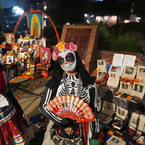 People join Olvera Street merchants in a night procession during the Day of the Death festival, Sunday, Oct. 26, 2025, in Los Angeles. (AP Photo/Damian Dovarganes)