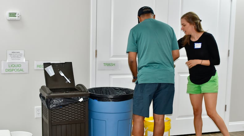 Kirkwood Presbyterian member Caroline McCormick (right) explains the church's composting guidelines. The church was named an Earth Care Congregation by the Presbyterian Church USA. Courtesy
