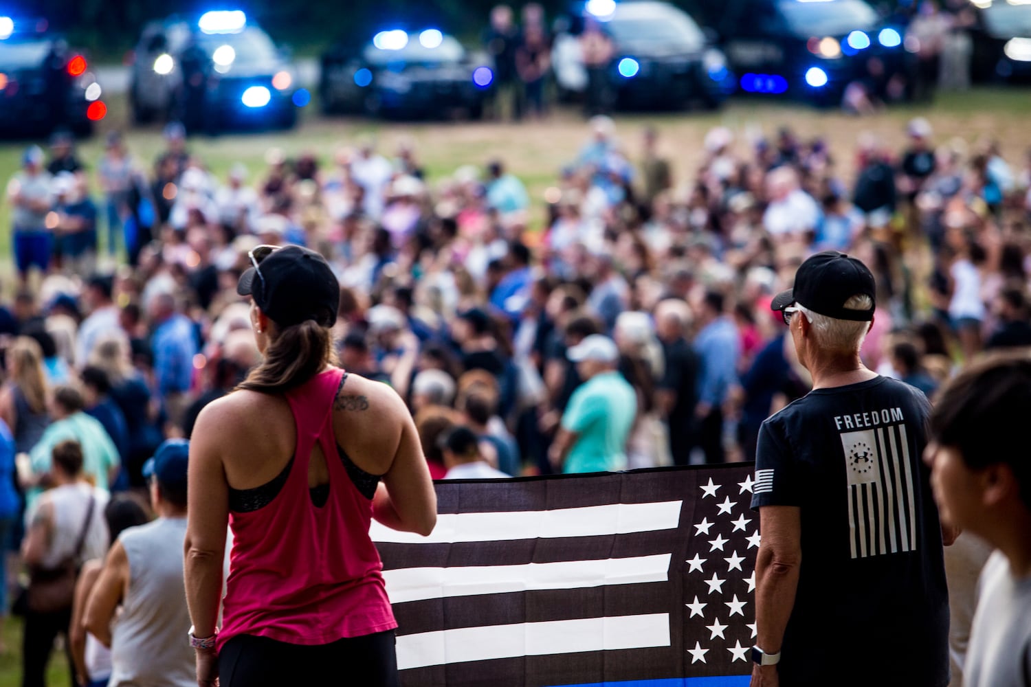 Members of the Holly Springs community and neighboring police departments gather at Barrett Park for a candlelight vigil for Police Officer Joe Burson on Friday, June 18, 2021 after he was killed during a traffic stop earlier this week.(Jenni Girtman for The Atlanta Journal-Constitution)