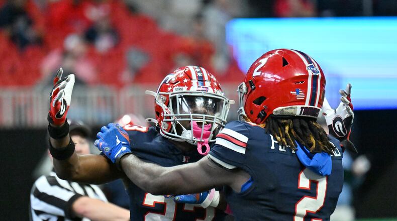 Toombs County's strong safety Alex Scott (left) and wide receiver Lagonza Hayward celebrate during the GHSA Class A-Division State Championship game at Mercedes-Benz Stadium on Tuesday, Dec. 17, 2024, in Atlanta. Toombs County has won its first-round game each of the past two seasons. (Hyosub Shin/AJC 2024)