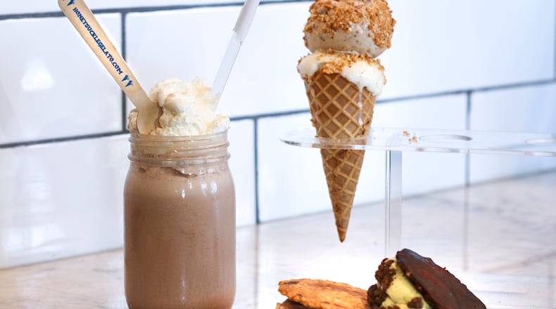 The Honeysuckle Gelato shop at Ponce City Market sells shakes, scoops and sandwiches. The shake was made with a scoop of dark chocolate and a scoop of bourbon gelato, then topped with whipped cream. There are chocolate chip and brown sandwiches, and a cone of brown butter gelato and honey fig gelato, topped with amaretti crumbles.