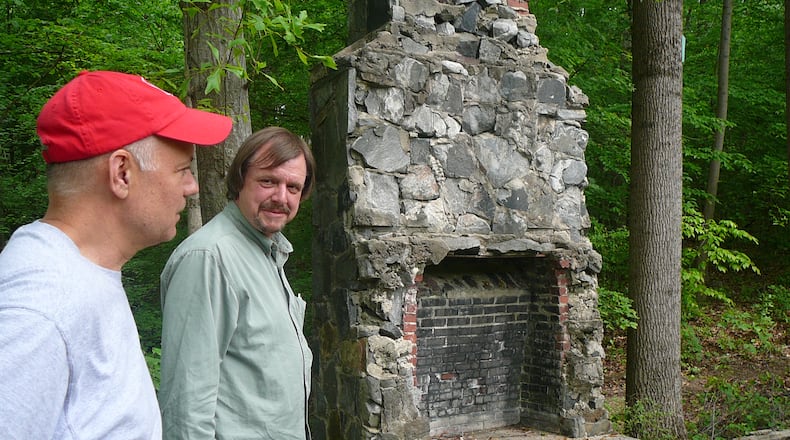 Don Penovi (left) and Keith Sharp explore the ruins of an old Boy Scout cabin in Spink-Collins Park, part of the Riverside neighborhood in northwest Atlanta.