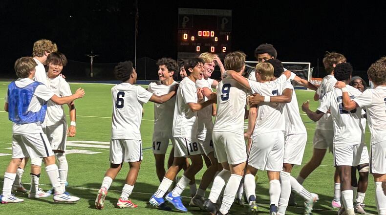 Whitefield Academy players celebrate on the field after their 1-0 victory over Hebron Christian in the Class 3A-A Private boys soccer championship game Tuesday, May 12, 2026, at St. Pius X High School in Atlanta. (Chip Saye/AJC)