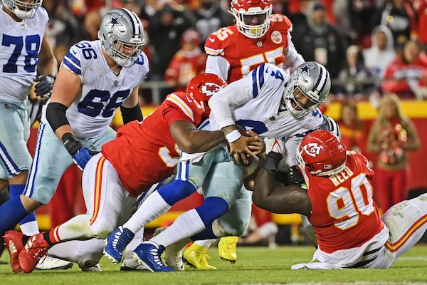 FILE - Kansas City Chiefs defensive tackle Jarran Reed (90) and defensive end Chris Jones (95) sack Dallas Cowboys quarterback Dak Prescott (4) during an NFL football game, Sunday, Nov. 21, 2021, in Kansas City, Mo. (AP Photo/Peter Aiken, File)