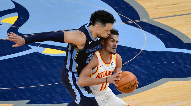 Memphis Grizzlies guard Dillon Brooks (24) fouls Atlanta Hawks guard Trae Young (11) in the second half Saturday, Dec. 26, 2020, in Memphis, Tenn. (Brandon Dill/AP)