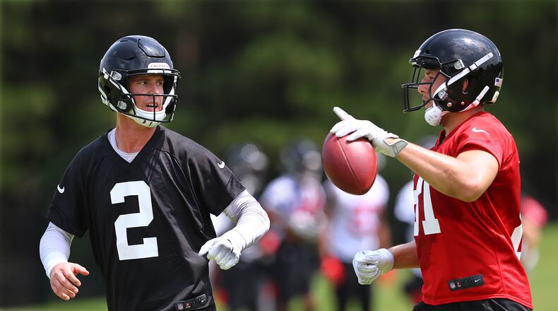 Atlanta Falcons quarterback Matt Ryan and tight end Austin Hooper confer after running a play during team practice Thursday, May 23, 2019, in Flowery Branch.