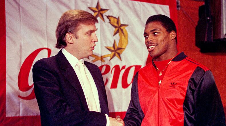Then-New Jersey Generals owner Donald Trump (left) shakes hands with Herschel Walker at a 1984 press conference in New York, after agreeing on a 4-year contract.
