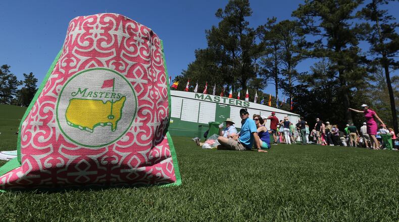 Fans relax and watch the practice rounds along the first fairway at Augusta National Golf Club Sunday.