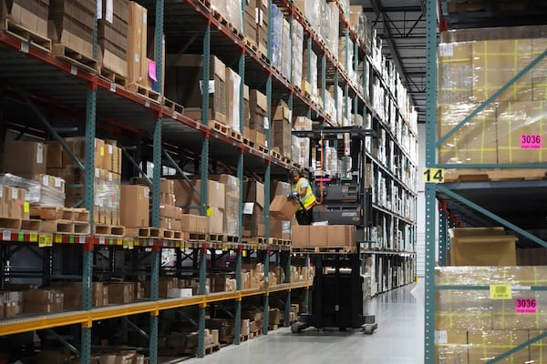 An employee of Learning Resources, an educational toy company, works at a warehouse in Vernon Hills, Ill., Friday, April 11, 2025. (AP Photo/Nam Y. Huh)