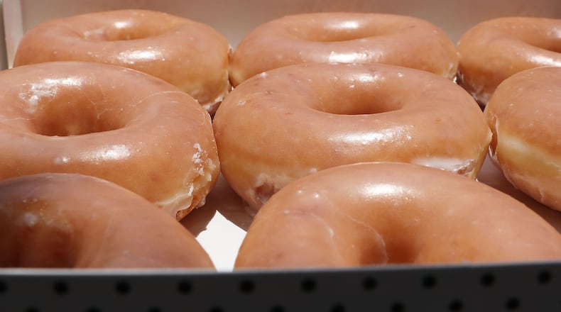 Krispy Kreme doughnuts are now being delivered to customers is some cities via UberEats. (Photo illustration by Joe Raedle/Getty Images)