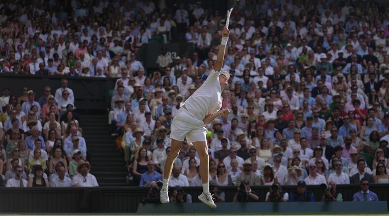 Jannik Sinner of Italy serves to Novak Djokovic of Serbia in their men's singles semifinal match at the Wimbledon Tennis Championships in London, Friday, July 10, 2026. (AP Photo/Brian Inganga)