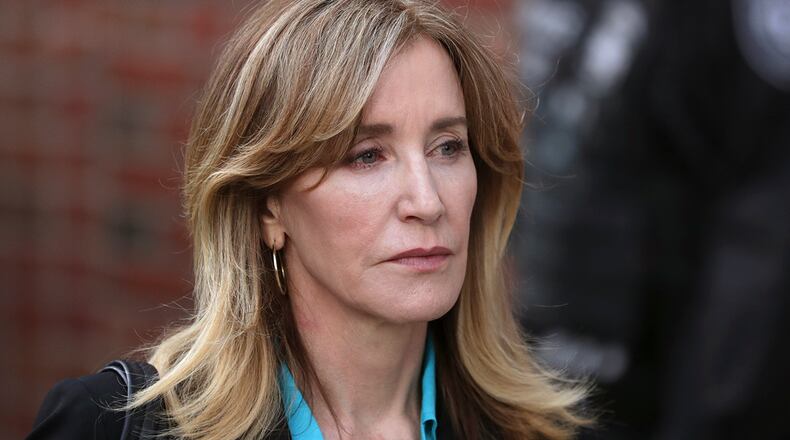 Actress Felicity Huffman departs federal court in Boston on Wednesday, April 3, 2019, after facing charges in a nationwide college admissions bribery scandal. (AP Photos/Charles Krupa)