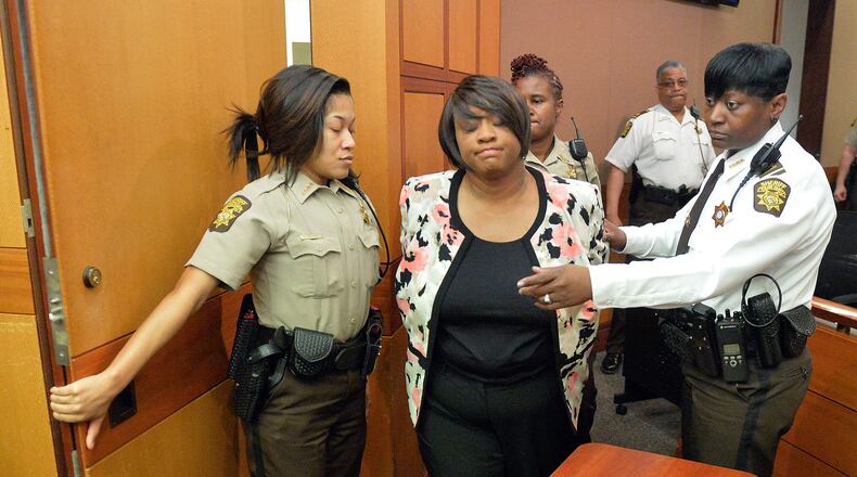 Tamara Cotman is led to a holding cell after a jury found her guilty in the Atlanta Public Schools test-cheating trial in 2015. (Kent D. Johnson/ Atlanta Journal-Constitution)