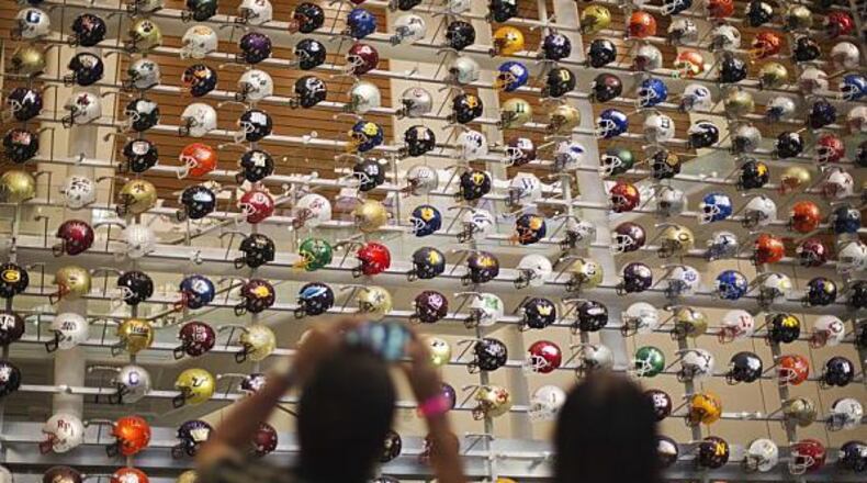 A three-story-high wall of helmets displays the headgear of the 768 teams that play college football at several different levels.