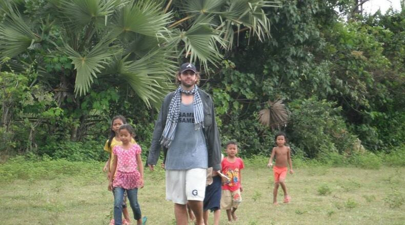 Former Georgia Tech basketball player Tysor Anderson with kids, in Cambodia with Peace Corps (Photo courtesy of Anderson/Driesell family.)