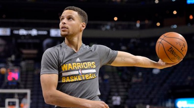 Golden State Warriors guard Stephen Curry warms up before an NBA basketball game Saturday, April 9, 2016, in Memphis, Tenn. (AP Photo/Brandon Dill)