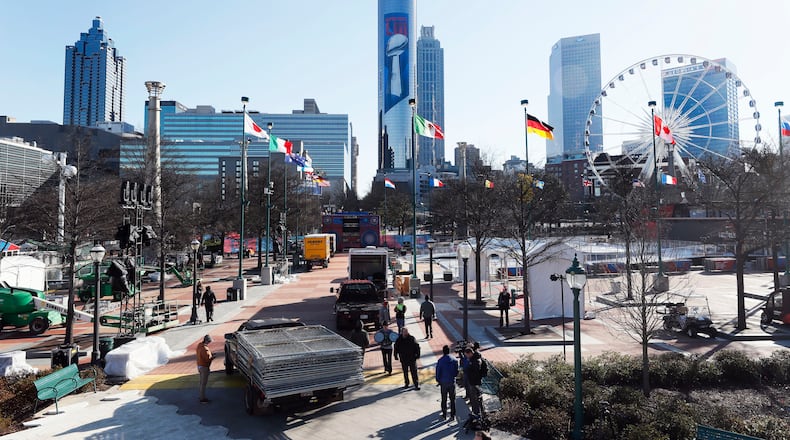 Workers at Centennial Park put the final touches on Super Bowl Live, which opened on Saturday. The fan village features concerts and other attractions. Bob Andres / bandres@ajc.com