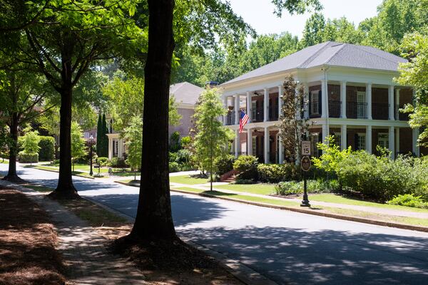 The home of Matt and Laurel Nelson sits on a tree-lined road in the gated Ellard community in Roswell, Wednesday, May 13, 2026. (Ben Gray for the AJC)