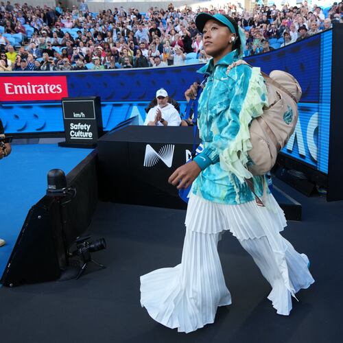 Naomi Osaka of Japan walks onto court for her second round match against Sorana Cirstea of Romaniaat the Australian Open tennis championship in Melbourne, Australia, Thursday, Jan. 22, 2026. (AP Photo/Dita Alangkara)