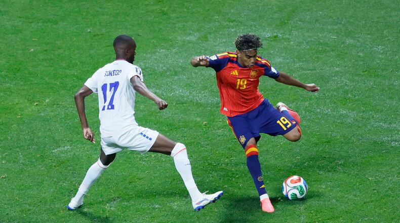 Spain forward Lamine Yamal (right) dribbles under pressure during a World Cup match against Cape Verde on Monday, June 15, 2026, at Atlanta Stadium. (Miguel Martinez/AJC)
