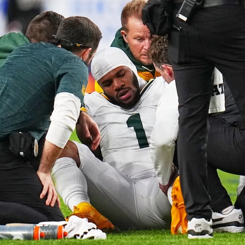Green Bay Packers' Micah Parsons reacts after an injury during the second half of an NFL football game against the Denver Broncos Sunday, Dec. 14, 2025, in Denver. (AP Photo/Jack Dempsey)