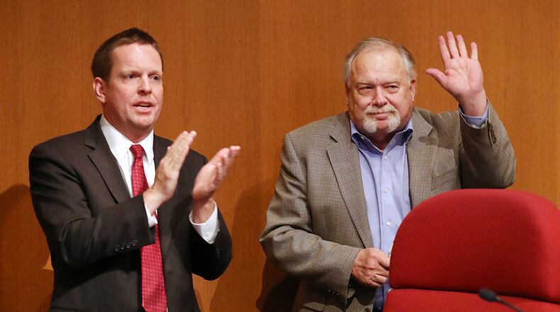 Smyrna Mayor Derek Norton (left) leads the applause for long-term, retiring Mayor Max Bacon during Norton's swearing-in ceremony in January 2020. In the spring, Norton formed a committee to review a new short-term rental proposal. Credit: Curtis Compton ccompton@ajc.com