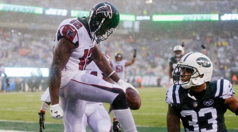 Atlanta Falcons wide receiver Mohamed Sanu (12) celebrates after catching a pass for a touchdown as New York Jets strong safety Jamal Adams (33) reacts during the second half of an NFL football game Sunday, Oct. 29, 2017, in East Rutherford, N.J. (AP Photo/Seth Wenig)