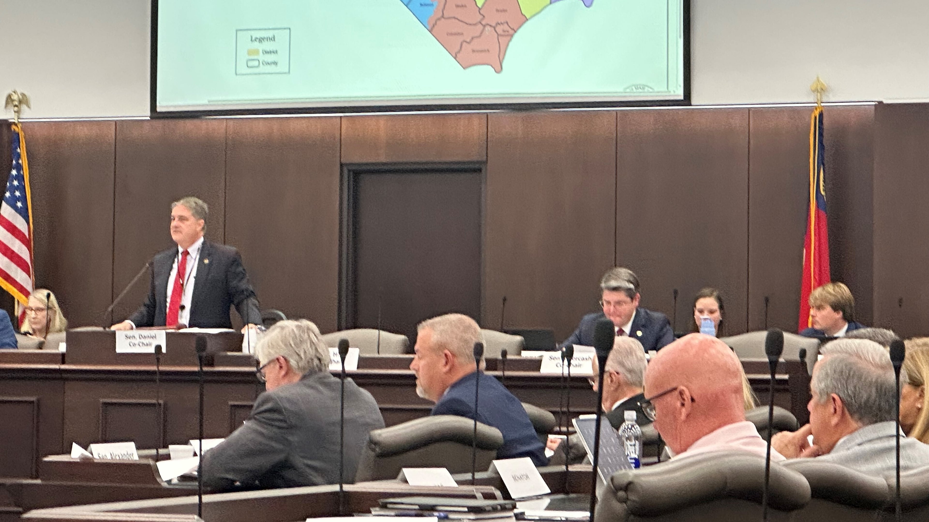 North Carolina state Sen. Warren Daniel, R-Burke (left and standing), presides over the Senate Committee on Elections while it considers legislation to redraw the state's U.S. House district map at the Legislative Office Building in Raleigh N.C., Monday, Oct. 20, 2025. (AP Photo/Gary D. Robertson)