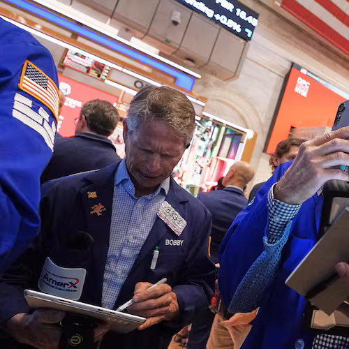 Traders Robert Charmak, left, and Mark Puetzer work on the floor of the New York Stock Exchange, Thursday, June 25, 2026. (AP Photo/Richard Drew)