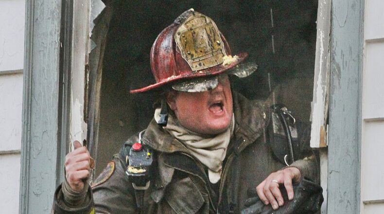 March 8, 2013: In an earlier fire, Chip Newell yells instructions as firefighters battled a blaze at a home in a Buckhead neighborhood. JOHN SPINK / JSPINK@AJC.COM