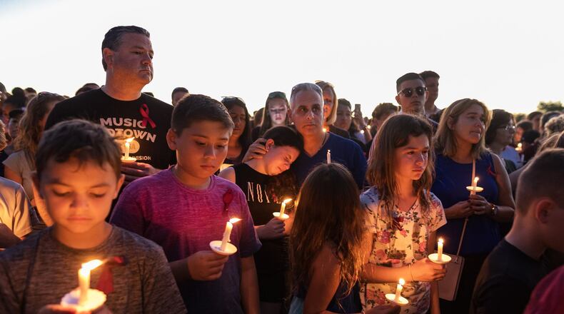 People attend a candlelit memorial service for the victims of the shooting at Marjory Stoneman Douglas High School that killed 17 people on February 15, 2018 in Parkland, Florida. (Greg Lovett / The Palm Beach Post)