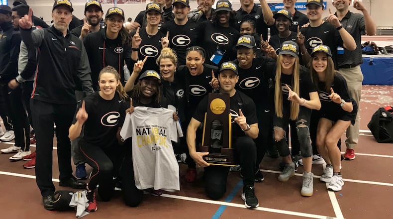 Georgia coach Petros Kyprianou and women's track team pose with the 2018 indoor national championship trophy, the school's first-ever title. (Photo from UGA Athletics)