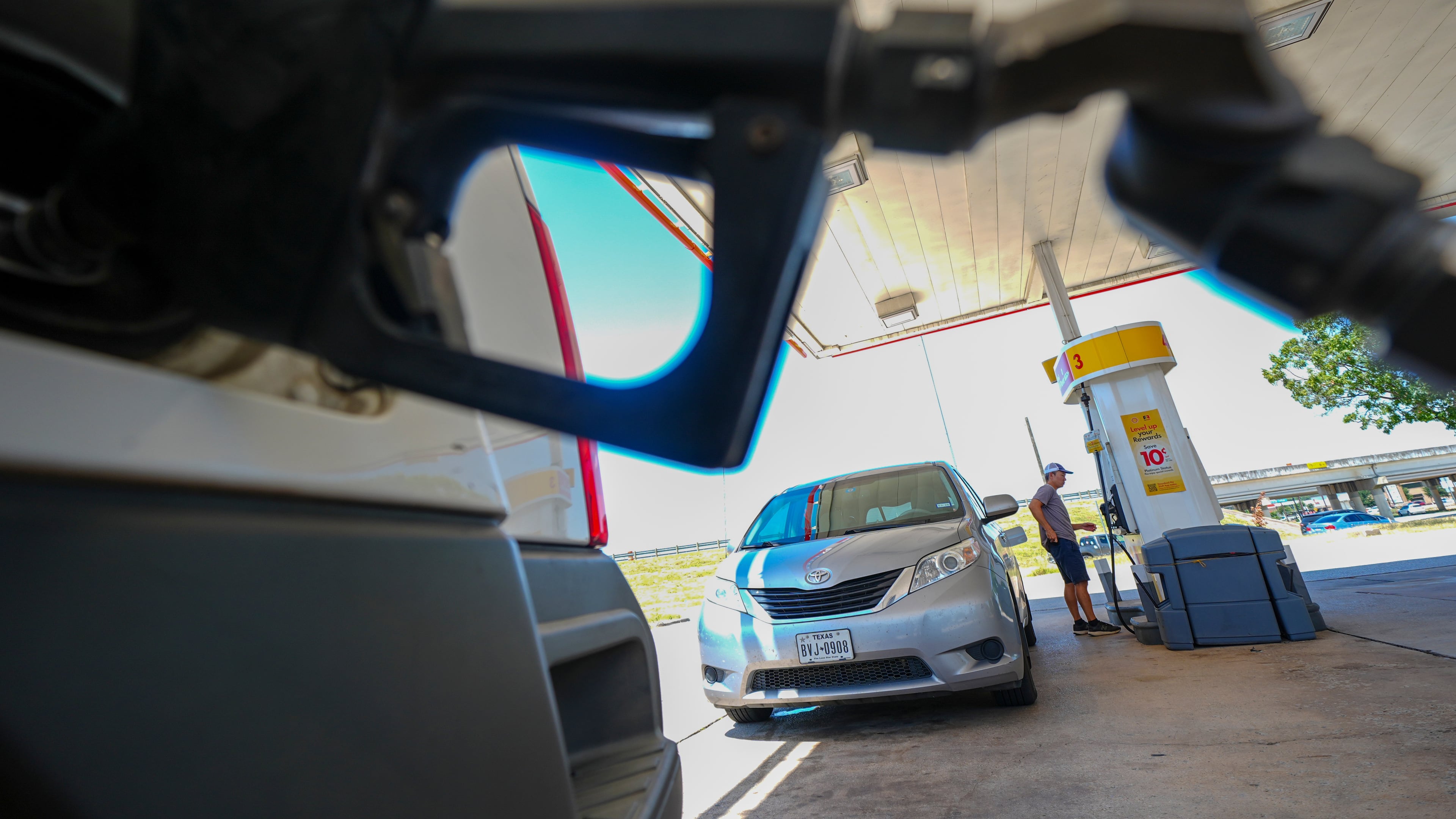 FILE - A person pays for fuel at a Shell gas station, Tuesday, July 29, 2025, in Arlington, Texas. (AP Photo/Julio Cortez, File)