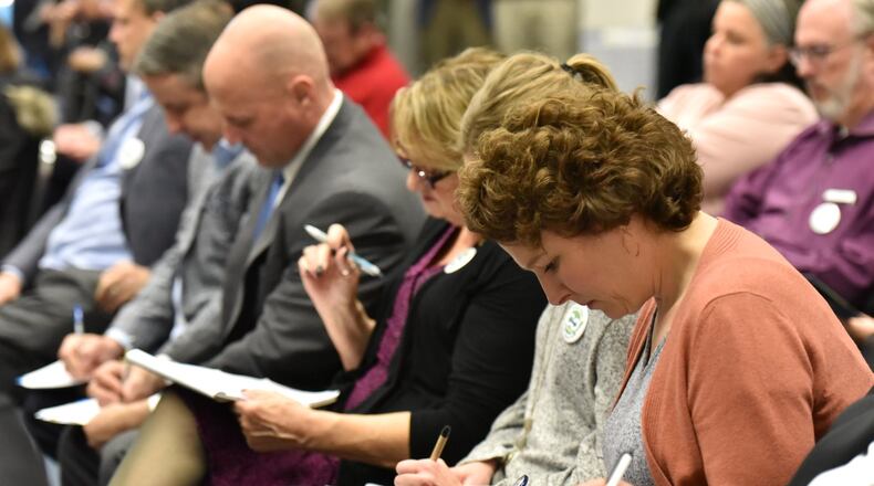 Participants fill in a volunteer form during a kickoff meeting Jan. 11, 2019, of Go Gwinnett, a group pushing for Gwinnett voters to approve of joining MARTA. HYOSUB SHIN / HSHIN@AJC.COM