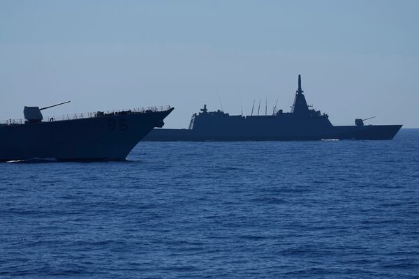 A US Navy USS Shoup (DDG86), left, and Japanese Maritime Self-Defence Force (JMSDF) frigate JS Noshiro. center, maneuver with Philippine Navy BRP Jose Rizal, not shown, during the Philippines United States Japan Multilateral Maritime Cooperative Activity off a disputed South China Sea shoal on Friday, March 28, 2025. (AP Photo/Aaron Favila)