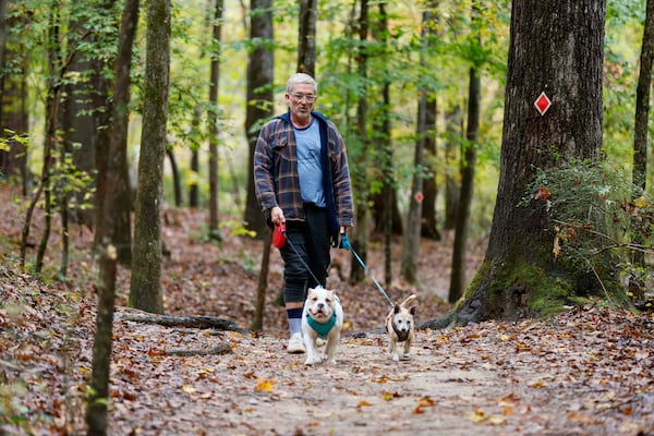 Terrance Wahl of Decatur takes a walk with his pets, Teddy and Tippi, at Sweetwater Creek State Park on Thursday, Oct. 30, 2025. He visits the park four to five times a year. (Miguel Martinez/AJC)
