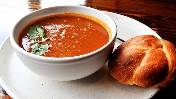 Tomato and Basil Soup with homemade (restaurant made) dinner roll and basil leaves on top, from the menu of Vincenza's Pizzaria, 9950 Jones Bridge Road, John Creek. (Chris Hunt for The Atlanta Journal-Constitution)