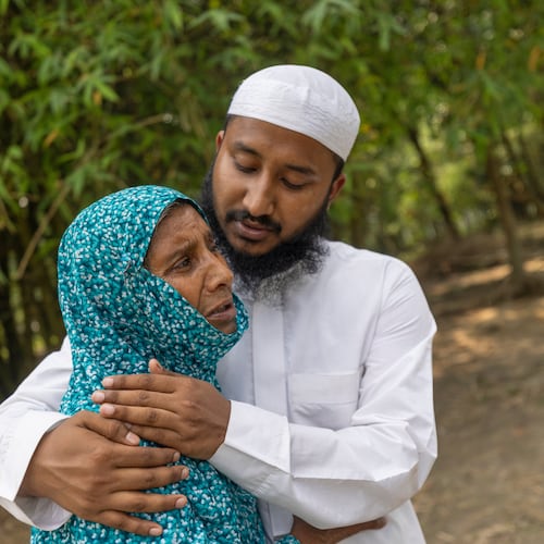 Maruf Hasan, brother of Mohammad Abdullah Al Mamun comforts his mother, Shahida Khatun, as she weeps at their home in Rasulpur village in Mymensingh district, Bangladesh, Friday, April 17, 2026. (AP Photo/Rajib Dhar)
