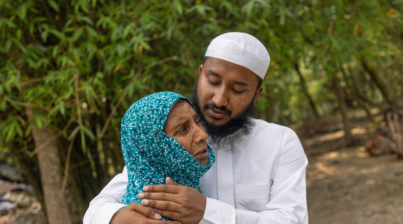 Maruf Hasan, brother of Mohammad Abdullah Al Mamun comforts his mother, Shahida Khatun, as she weeps at their home in Rasulpur village in Mymensingh district, Bangladesh, Friday, April 17, 2026. (AP Photo/Rajib Dhar)