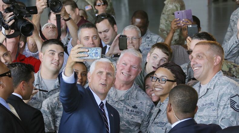 Vice President Mike Pence take a selfie using the phone of Senior Airman Lauren Douglas with the military crowd at Dobbins Air Reserve Base in Marietta on Friday, June 9, 2017.