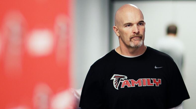 Atlanta Falcons head coach Dan Quinn walks into a press conference Wednesday in Flowery Branch.